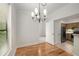 Charming dining area with hardwood floors, chandelier, and kitchen view at 3777 Peachtree Ne Rd # 1536, Atlanta, GA 30319