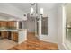 Cozy dining area with chandelier, hardwood floors, and kitchen access at 3777 Peachtree Ne Rd # 1536, Atlanta, GA 30319