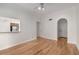 Open-concept living area with hardwood floors, white walls, and view to kitchen at 3777 Peachtree Ne Rd # 1536, Atlanta, GA 30319