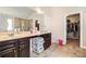 Bright bathroom featuring double vanity sinks, large mirror, and a walk-in closet with ample storage space at 3780 Casual Ridge Way, Loganville, GA 30052