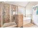 Bathroom featuring a glass shower with tile, bathtub with tile accent, and a window at 3780 Casual Ridge Way, Loganville, GA 30052