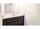 Bathroom vanity featuring a sink and dark wood cabinets, set against a white wall at 3780 Casual Ridge Way, Loganville, GA 30052