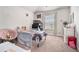 bedroom with playful decor, window, comfortable seating, and carpet flooring at 3780 Casual Ridge Way, Loganville, GA 30052