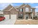 Charming two-story brick home featuring a two-car garage and inviting front porch at 3780 Casual Ridge Way, Loganville, GA 30052