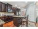 Well-equipped kitchen featuring dark wood cabinets, granite countertops, stainless steel appliances, and island at 3780 Casual Ridge Way, Loganville, GA 30052