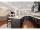 Spacious kitchen featuring dark wood cabinets, granite countertops, stainless steel appliances, and island with bar seating at 3780 Casual Ridge Way, Loganville, GA 30052