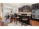 Kitchen featuring dark wood cabinets, granite countertops, stainless steel appliances, and an island with bar seating at 3780 Casual Ridge Way, Loganville, GA 30052