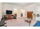 Cozy living room with TV, glass coffee table and neutral carpet, creating a comfortable atmosphere at 3780 Casual Ridge Way, Loganville, GA 30052