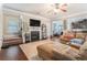 Cozy living room featuring a fireplace, open layout, and seamless flow to the kitchen at 3780 Casual Ridge Way, Loganville, GA 30052