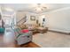 Comfortable living room featuring hardwood floors, ample seating, and access to other living areas at 3780 Casual Ridge Way, Loganville, GA 30052