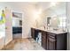 Main bathroom with a double vanity, marble countertops, and a view of the sleeping area at 3780 Casual Ridge Way, Loganville, GA 30052