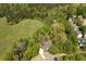 Aerial view of home on acreage surrounded by green trees and pasture land at 402 Glenhurst Trce, Canton, GA 30115