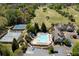 An aerial view showcasing golf course, pool, tennis courts and clubhouse within the community at 402 Glenhurst Trce, Canton, GA 30115