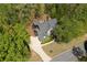 Drone view of home with large backyard deck and surrounding mature trees at 402 Glenhurst Trce, Canton, GA 30115