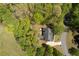 Aerial view of home on wooded lot with curved driveway and green grass at 402 Glenhurst Trce, Canton, GA 30115