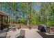 Inviting back deck with plenty of seating and a grill, surrounded by mature trees and landscaping at 402 Glenhurst Trce, Canton, GA 30115