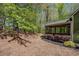Backyard view showcasing a screened porch, back deck, and surrounding lush greenery at 402 Glenhurst Trce, Canton, GA 30115