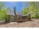 Backyard of a home with a large deck, screened porch, and mature trees at 402 Glenhurst Trce, Canton, GA 30115