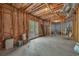 Unfinished basement area with exposed framework and a walkout to the backyard, ready to be customized at 402 Glenhurst Trce, Canton, GA 30115