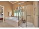 A relaxing spa style bath with tile surround, jetted tub, walk in shower and views of nature at 402 Glenhurst Trce, Canton, GA 30115