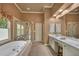 A spacious bathroom boasts a jetted tub, a walk-in shower, a white vanity with double sinks and sconce lighting at 402 Glenhurst Trce, Canton, GA 30115