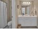 Well-lit bathroom featuring a double sink vanity, toilet, and shower with neutral wall tones at 402 Glenhurst Trce, Canton, GA 30115