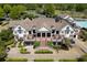 A full view of the community clubhouse featuring a patio with tables and golf cart parking at 402 Glenhurst Trce, Canton, GA 30115