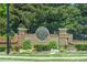 Woodmont Golf and Country Club entrance sign with brick pillars and landscaping at 402 Glenhurst Trce, Canton, GA 30115