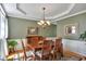 Elegant dining room features a coffered ceiling, wooden table, and large windows for ample natural light at 402 Glenhurst Trce, Canton, GA 30115
