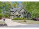 Charming two-story home with lush landscaping, a well-maintained lawn, and classic architectural details at 402 Glenhurst Trce, Canton, GA 30115