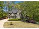 Beautiful two-story home with lush green landscaping and a long driveway at 402 Glenhurst Trce, Canton, GA 30115