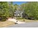 Charming home with mature trees, lush lawn, and a paved driveway at 402 Glenhurst Trce, Canton, GA 30115