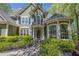 Elegant home exterior featuring a covered front entrance with detailed columns and manicured landscaping at 402 Glenhurst Trce, Canton, GA 30115