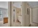 View of hallway into attached rooms with neutral paint and carpet and a linen closet at 402 Glenhurst Trce, Canton, GA 30115