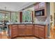Kitchen features a granite countertops, wood cabinets, hardwood floors, and a view to the outside deck at 402 Glenhurst Trce, Canton, GA 30115