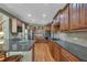 Kitchen features wood cabinets, granite countertops, stainless steel appliances, and hardwood floors at 402 Glenhurst Trce, Canton, GA 30115