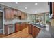 Kitchen features stainless steel appliances, granite countertops, custom cabinetry, and a view to the dining area at 402 Glenhurst Trce, Canton, GA 30115