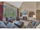 Inviting living room with a fireplace, built-in shelves, and large windows offering scenic views at 402 Glenhurst Trce, Canton, GA 30115