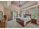 Spacious main bedroom features a tray ceiling, plush carpet, and a private balcony at 402 Glenhurst Trce, Canton, GA 30115