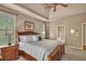 Main bedroom features tray ceilings, plush carpet, and a window view to the outside at 402 Glenhurst Trce, Canton, GA 30115