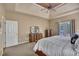 This bedroom offers plush carpet, tray ceilings, and access to a private balcony at 402 Glenhurst Trce, Canton, GA 30115