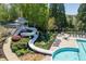 View of a community pool with a slide and seating at 402 Glenhurst Trce, Canton, GA 30115