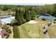 Features of the community pool, including a lap pool, lounge chairs, tennis courts, and lush landscaping at 402 Glenhurst Trce, Canton, GA 30115
