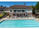 Rear view of community clubhouse featuring pool with lounge seating at 402 Glenhurst Trce, Canton, GA 30115