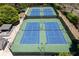 Close aerial view of four fenced and lighted tennis courts available to the community at 402 Glenhurst Trce, Canton, GA 30115