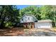 Charming two-story home featuring a brick facade, light siding, and a spacious two car garage at 4402 Sebring Walk, Decatur, GA 30034