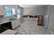Bright kitchen with ample white cabinetry, sleek vinyl flooring, and an adjacent living space at 4402 Sebring Walk, Decatur, GA 30034