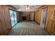 Cozy living room with wood paneling, brick fireplace, and sliding glass door to the exterior at 4402 Sebring Walk, Decatur, GA 30034