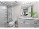 This bright bathroom features a glass enclosed shower, marbled vanity, and contemporary light fixture at 1150 Collier Nw Rd # E3, Atlanta, GA 30318