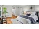 Comfortable bedroom featuring hardwood floors, soft, neutral colors, and a stylish decorative plant at 1150 Collier Nw Rd # E3, Atlanta, GA 30318